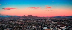 Las Vegas City Skyline panorama with sunset, mountain, luxury hotels and streets.