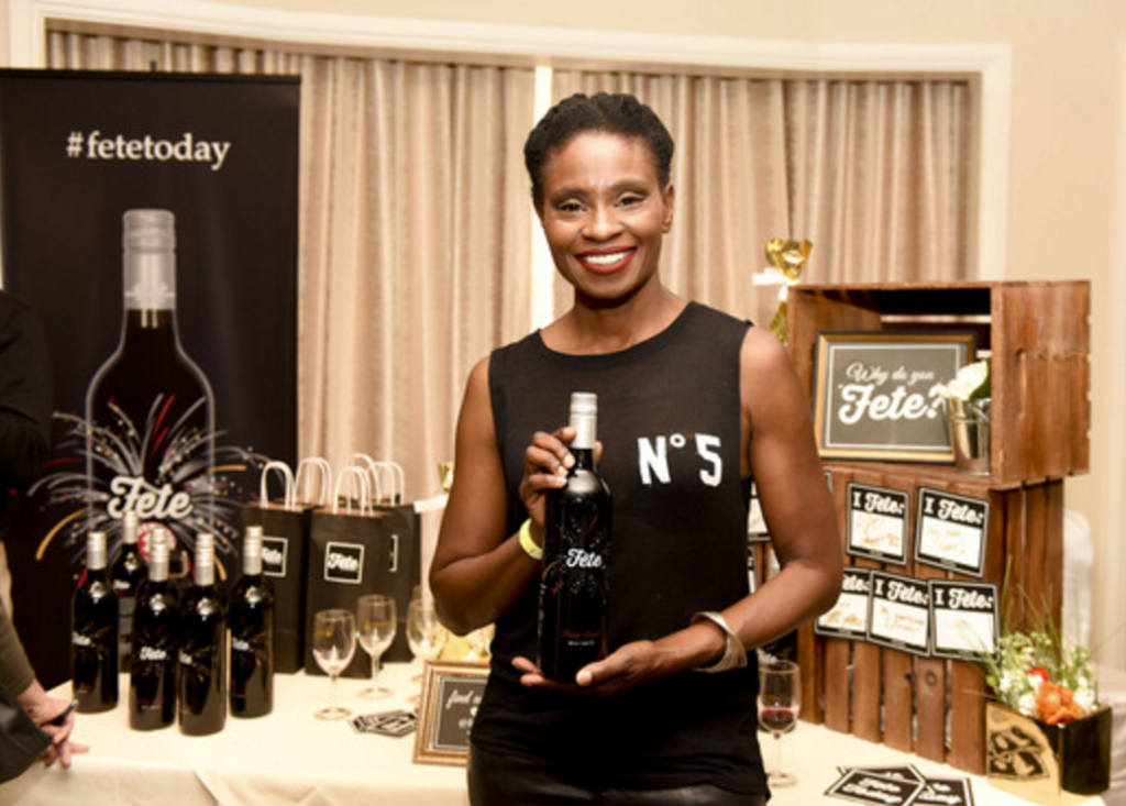 Adina Porter happily shows off her bottle of Fete Today wine.