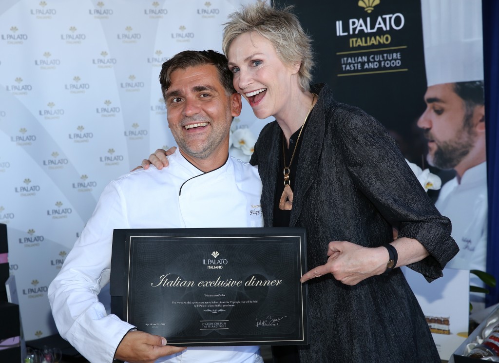 Actress Jane Lynch checks out Chef Filippo Sinisgalli at the PILOT PEN & GBK Pre-Emmy Luxury Lounge. Photo Credit: Maury Phillips/Getty Images for GBK Productions.