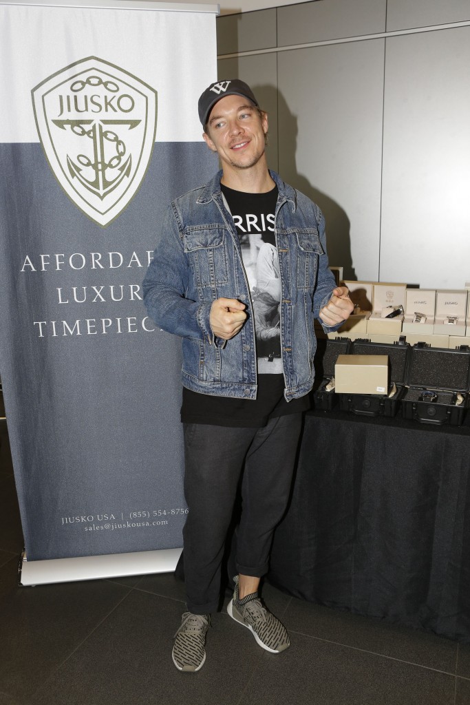 DJ Diplo checks out the Make A Wish Foundation booth at the GBK Pre-Grammy Lounge at the McLaren Auto Gallery. (Photo by Tiffany Rose/Getty Images for GBK)