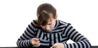 Girl putting on her contact lenses