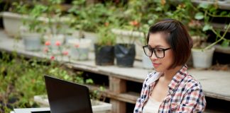 Woman working on computer outdoors