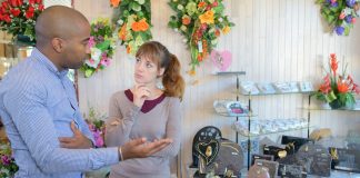 two people talking at a jewelry display