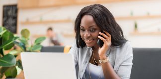 Woman using smartphone and laptop