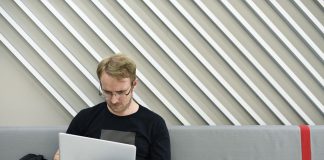 Man sitting alone and working on his laptop