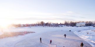 People playing ice hockey on frozen ground