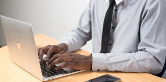 Man typing on Apple laptop