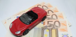 Red toy car with money