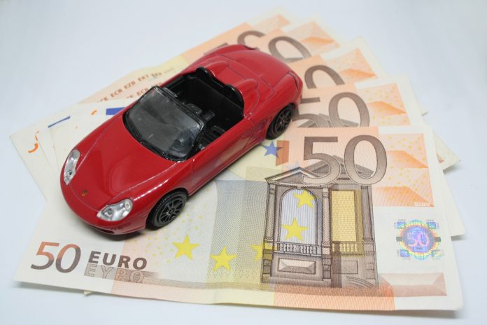 Red toy car with money