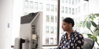 Woman typing at her computer doing marketing work