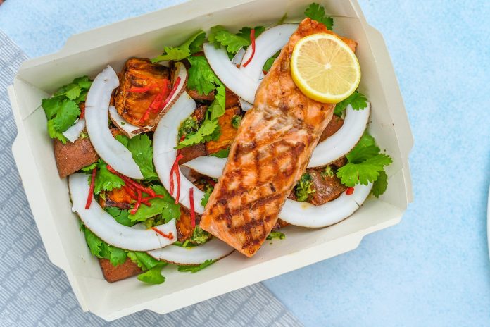 Box filled with greens and salmon