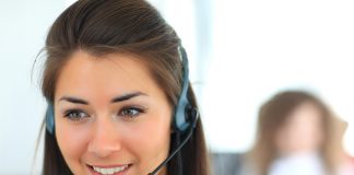 Female customer support operator with headset and smiling