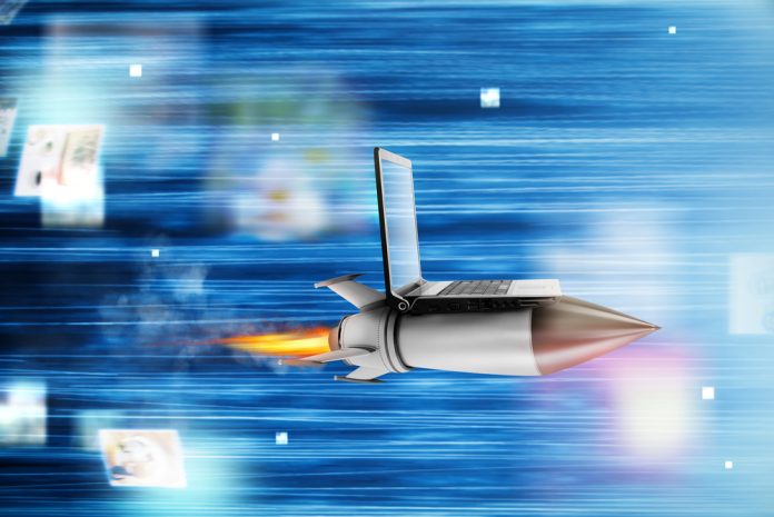 Fast internet concept with a laptop over a speedy rocket