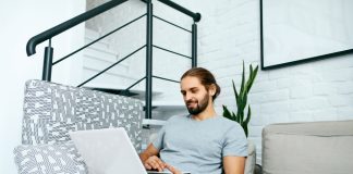 Young Man With Laptop At Home, Sitting on Sofa