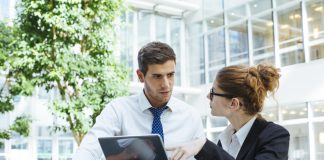 Businesspeople talking at computer