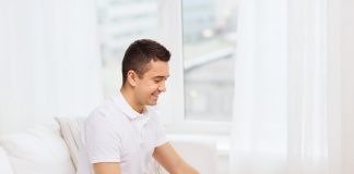 man with papers and calculator at home