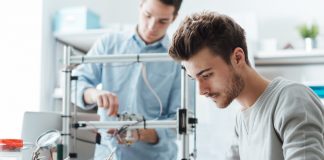 Engineering students working in the lab testing product