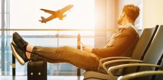 Man watches plane take off at airport