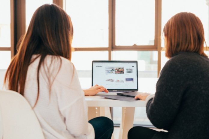 Two women working on laptop