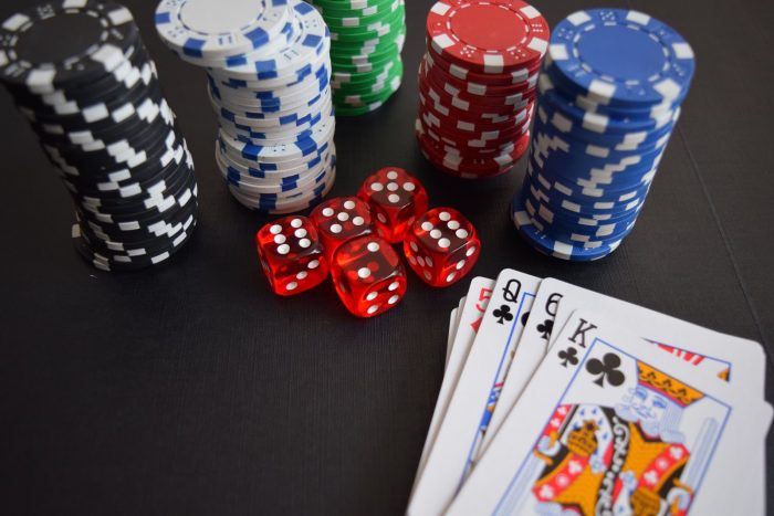 Dice poker chips and cards on a table.