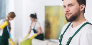 Young cleaning man in uniform planning new job