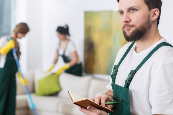 Young cleaning man in uniform planning new job
