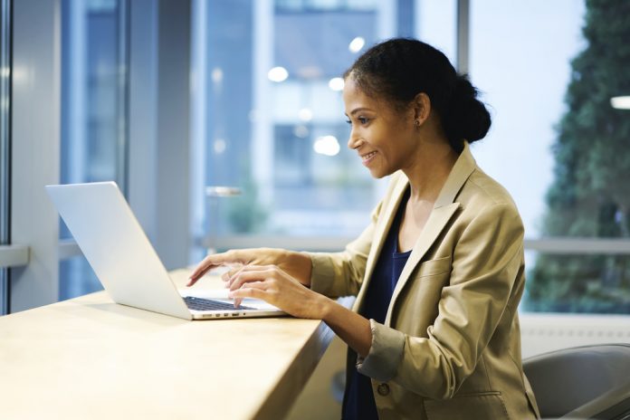 Female sitting and working at laptop