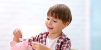 Boy with piggy bank on blurred background