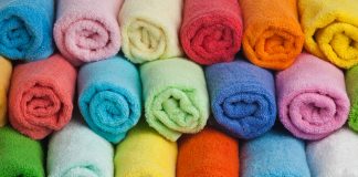 Set of colored towels on white background