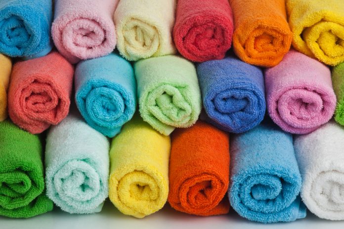 Set of colored towels on white background