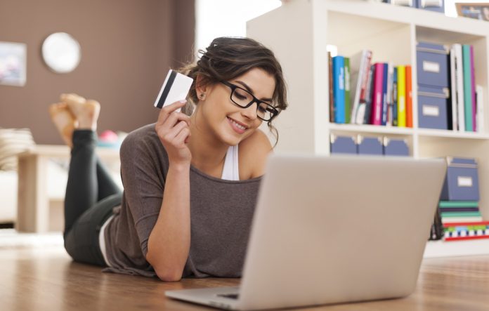 Happy woman doing online shopping at home