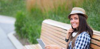 Woman with laptop on a bench