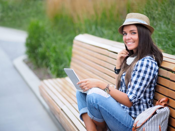 Woman with laptop on a bench