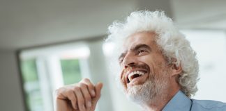 Cheerful smiling businessman looking away and laughing