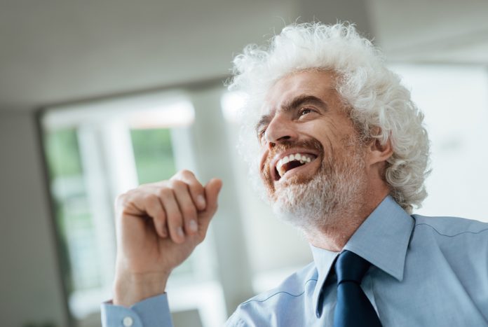 Cheerful smiling businessman looking away and laughing