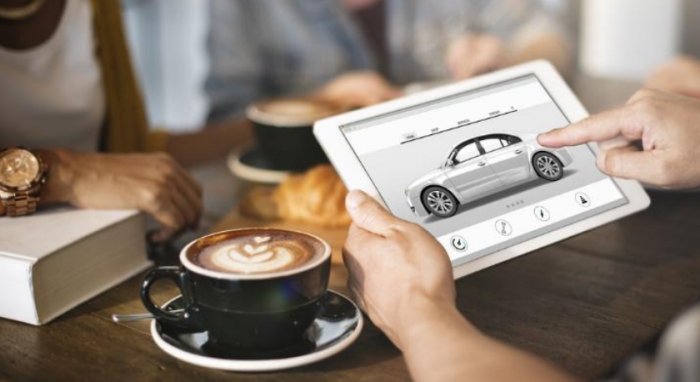 Person pointing at car design on tablet