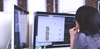 Businesswoman working at computer monitors