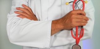 Doctor in white coat holding stethoscope