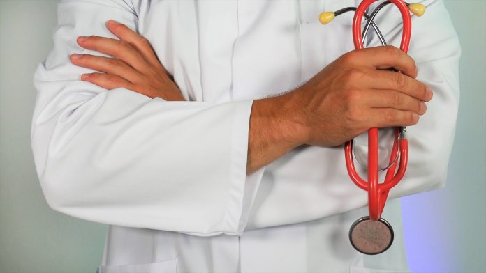 Doctor in white coat holding stethoscope