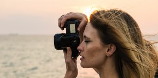 Woman taking picture of ocean