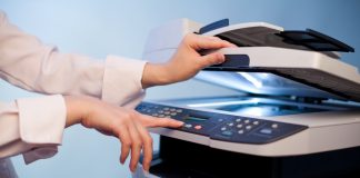 Woman's hand with working copier