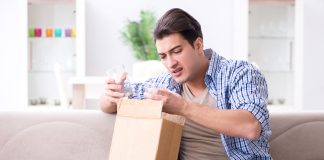 Man receiving wrong parcel with glasses