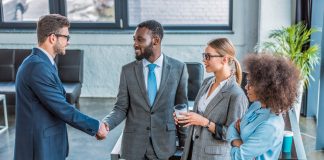 Businesspeople shaking hands in office