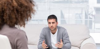 Depressed man speaking to a therapist