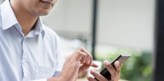 Businessman using smartphone while having lunch