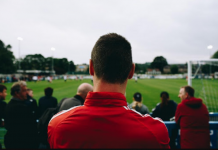 Man in red shirt looking at field