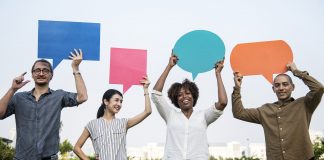 People holding posters shaped like comments