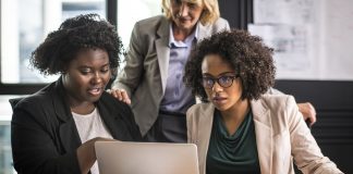 Business team looking at laptop