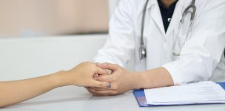 Doctor holding patient's hand