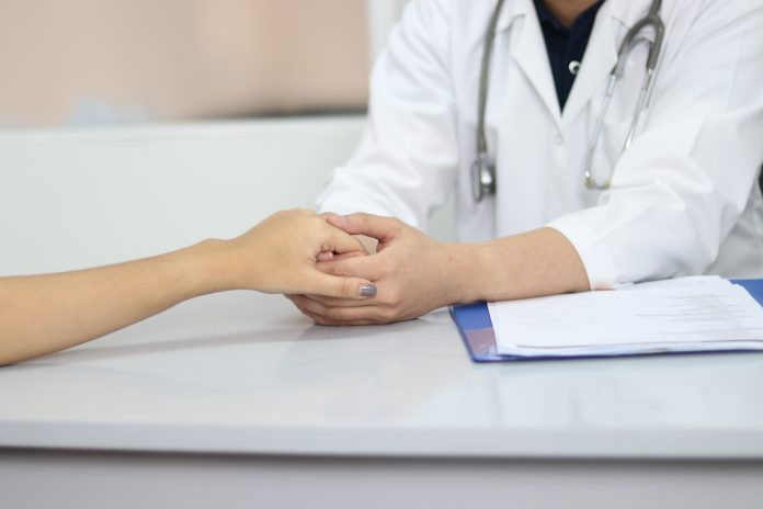 Doctor holding patient's hand